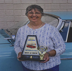 Anne Armstrong holding best of show trophy