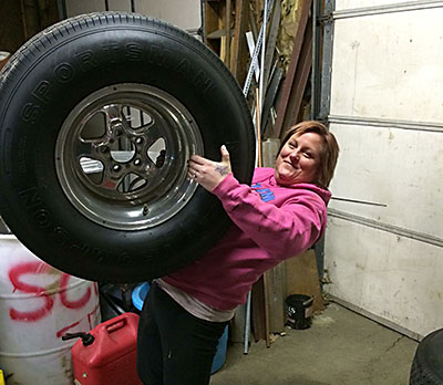 Samantha holding her wheel & tire for the 65 Falcon